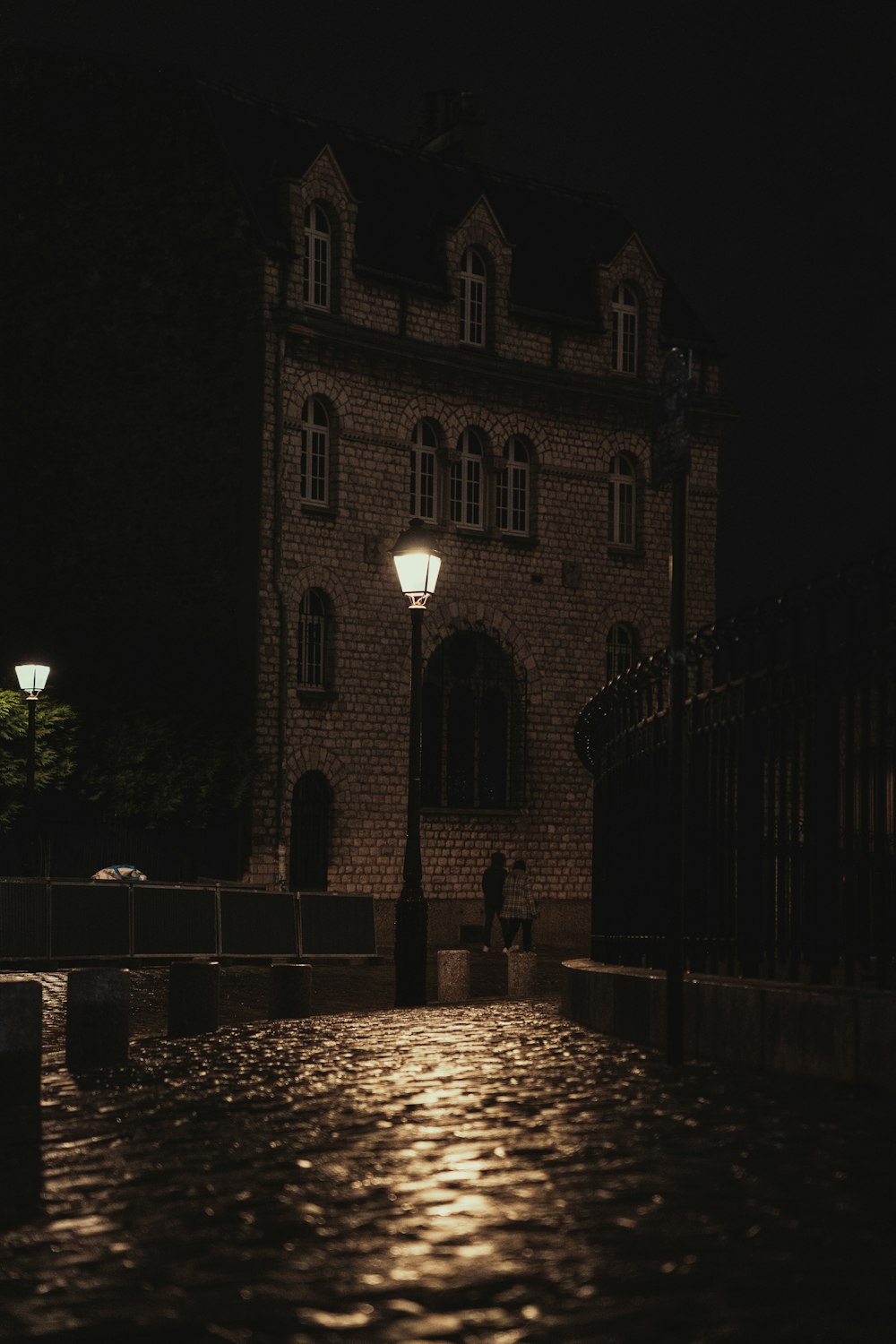 a person standing in front of a building at night