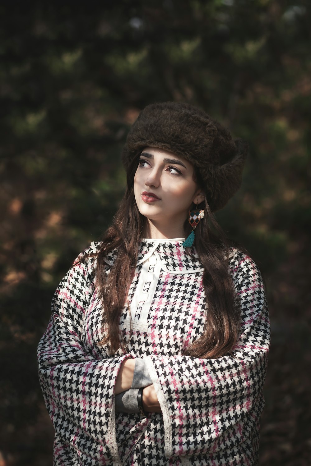 a woman wearing a black and white coat and hat