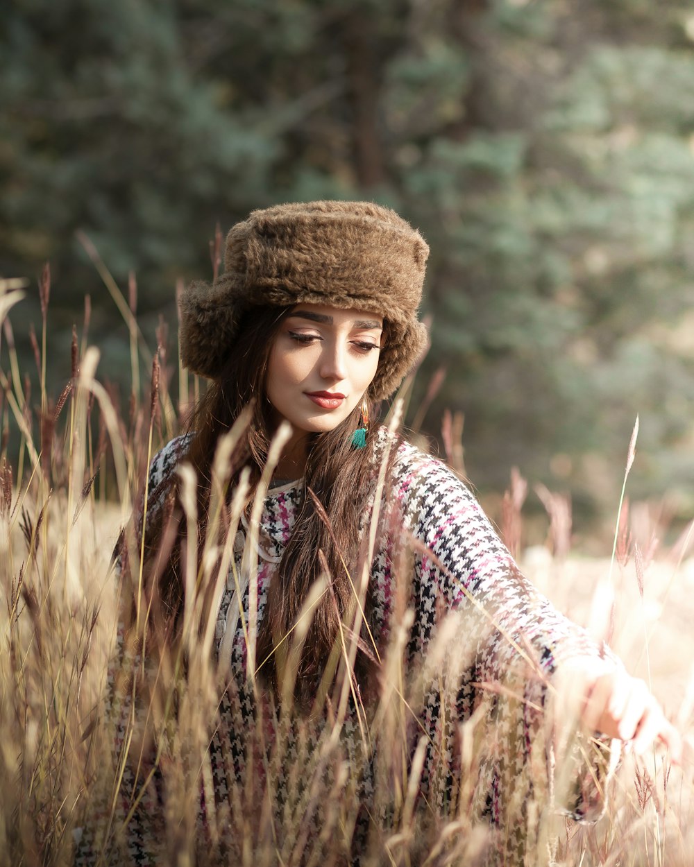 a woman sitting in a field of tall grass