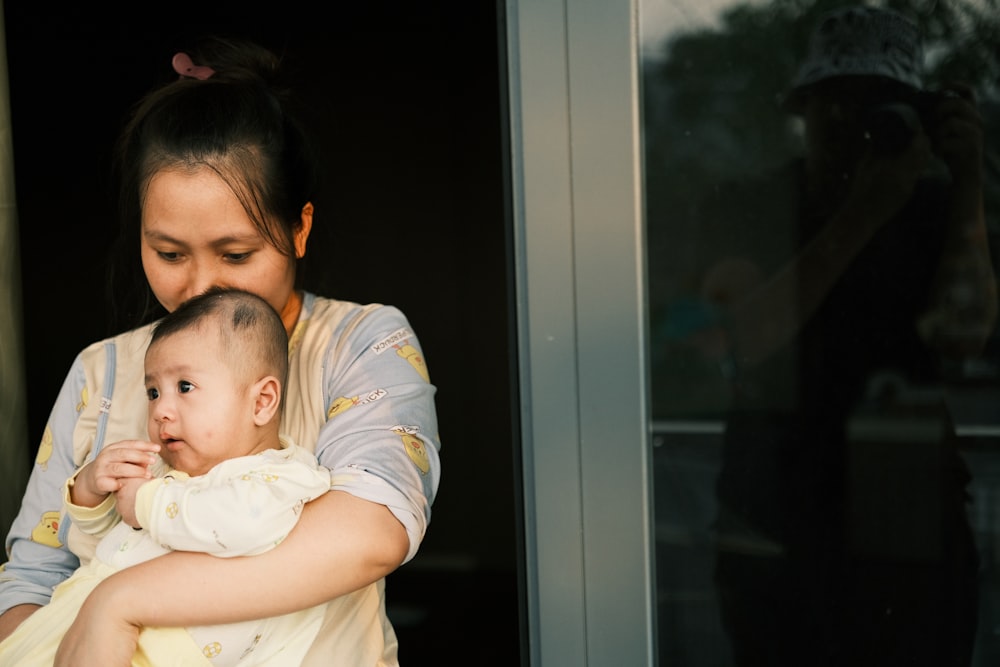 a woman holding a baby in her arms