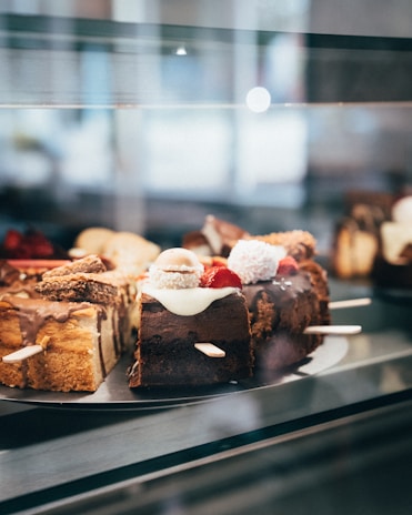 a display case filled with lots of different types of cakes