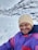 A happy customer skiing on a snowy mountain.