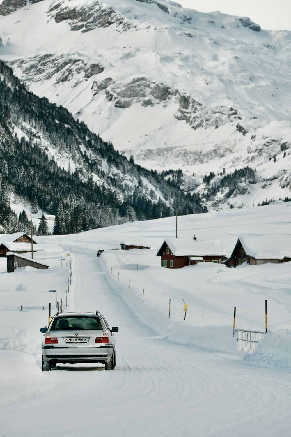 a car driving down a snow covered road