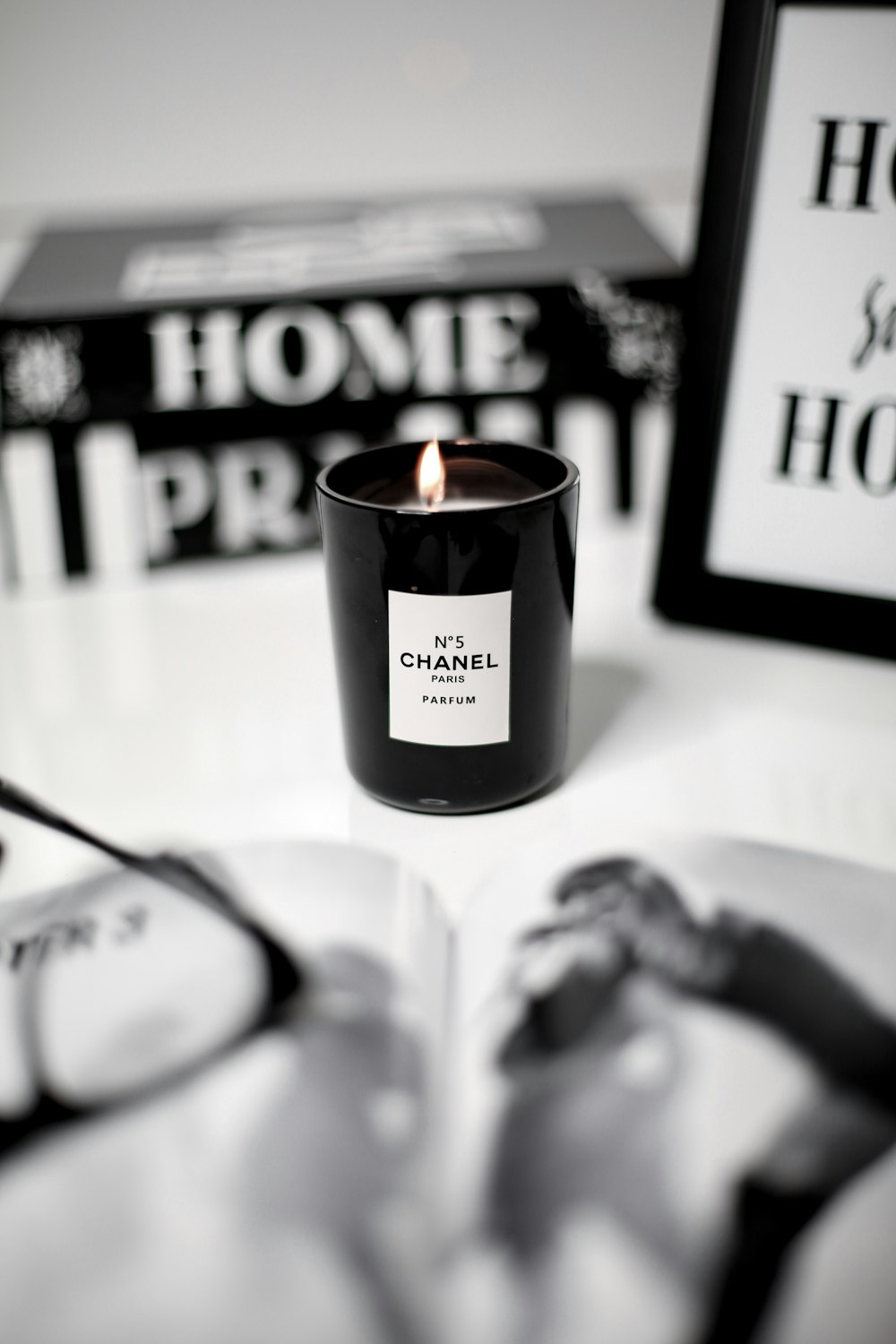 a candle sitting on top of a table next to a pair of glasses