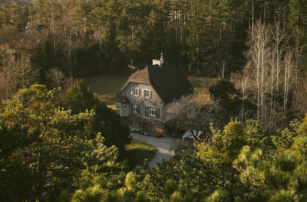 an aerial view of a house surrounded by trees