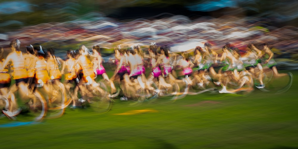 a blurry photo of a group of people riding bicycles