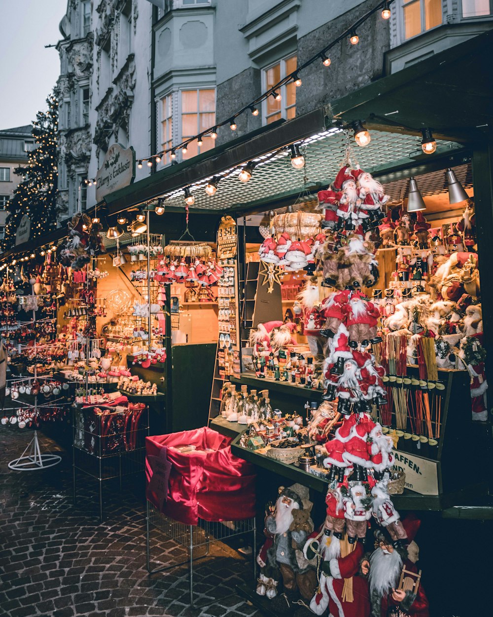 a christmas market with lots of decorations and lights