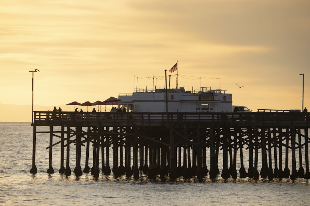 a boat is docked at the end of a pier