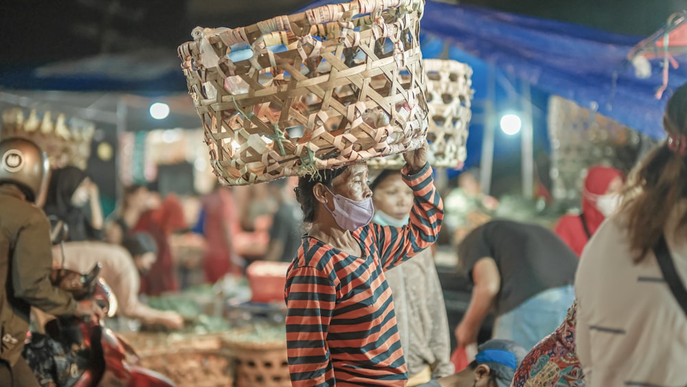 a woman carrying a basket on her head