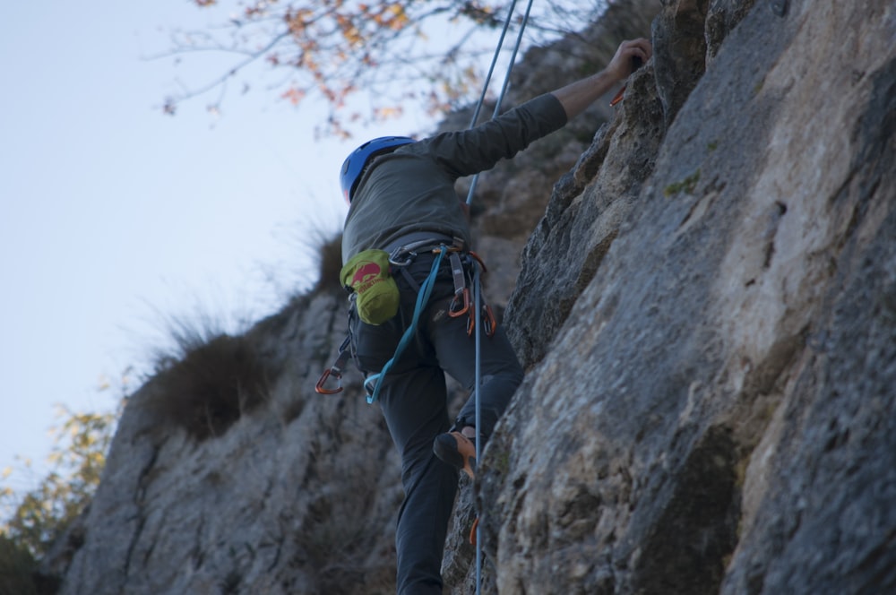 a man climbing up the side of a mountain