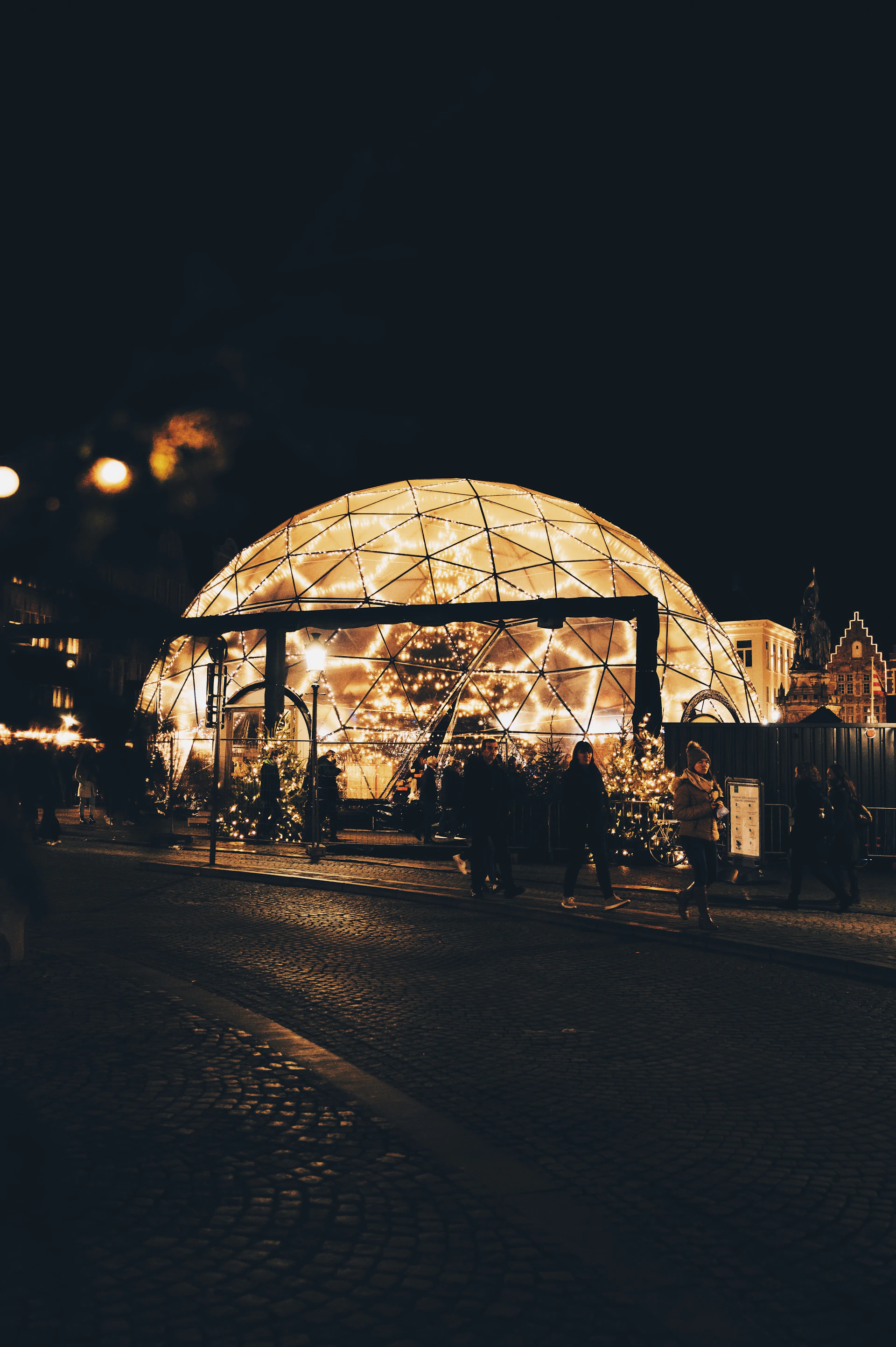 a lit up building on a city street at night