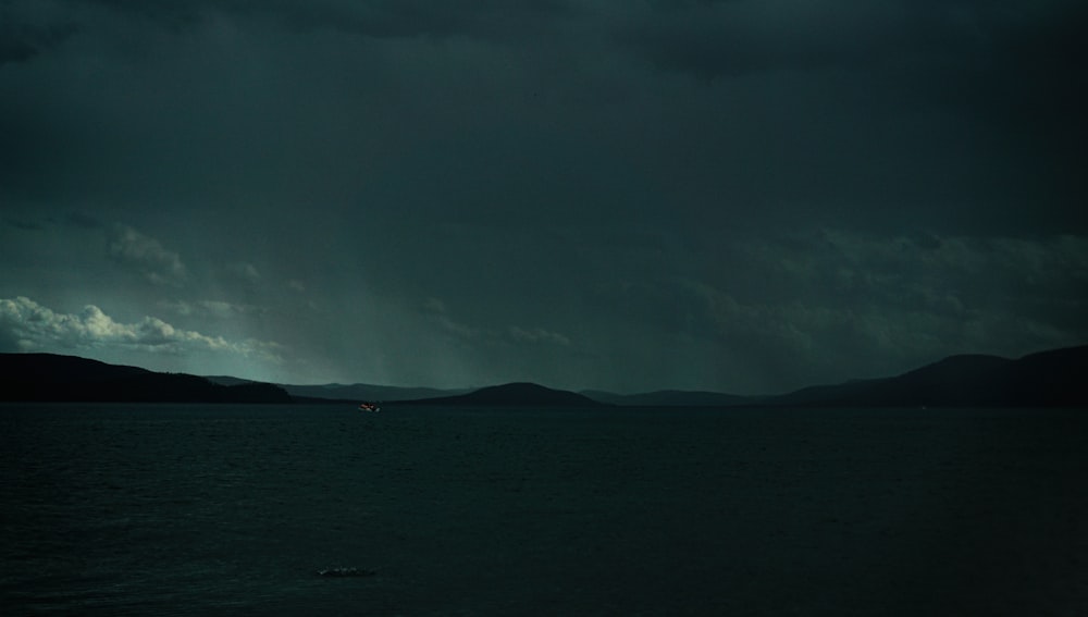 a dark sky over a large body of water