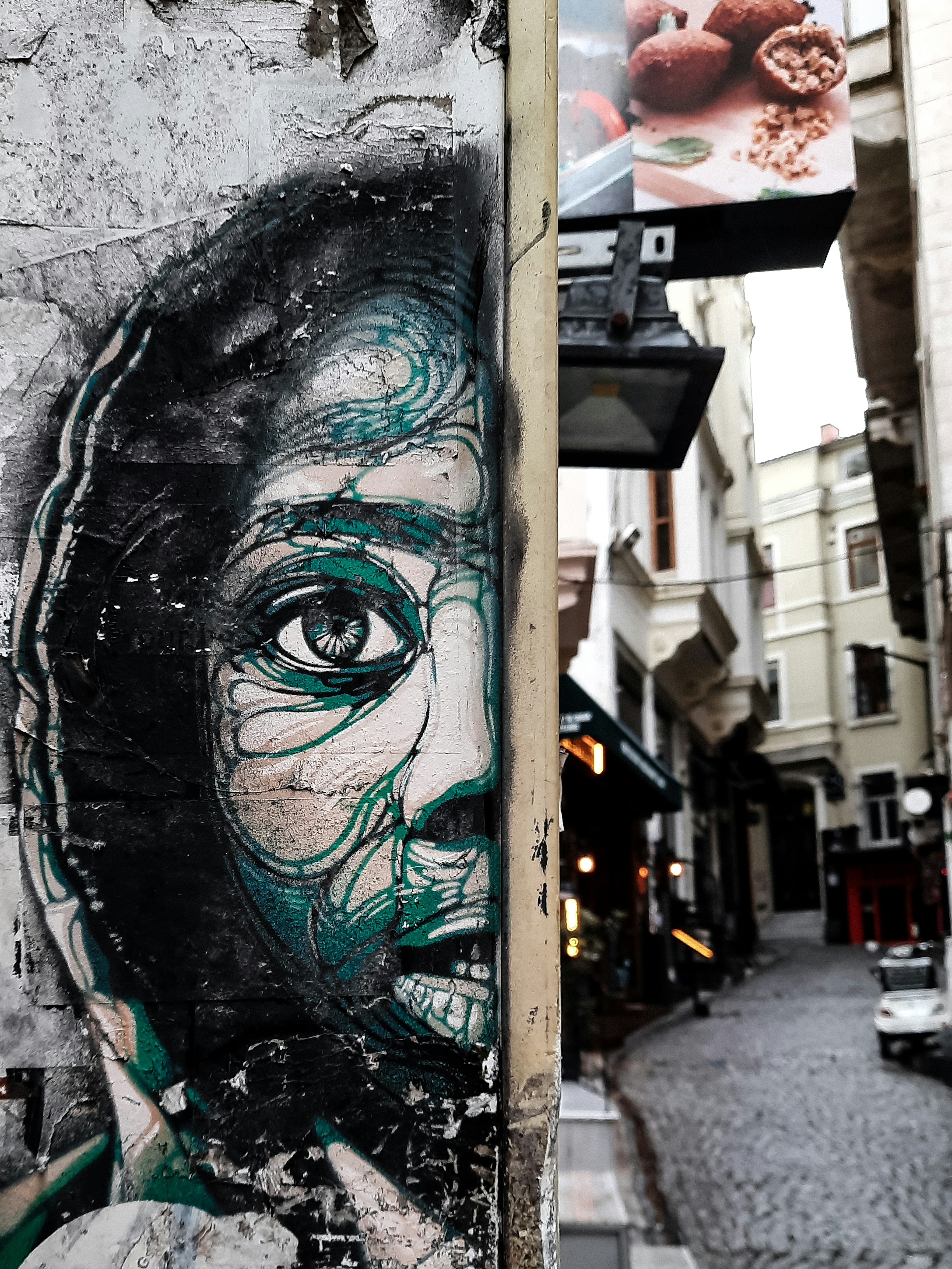 a wall with a painting of a man's face on it