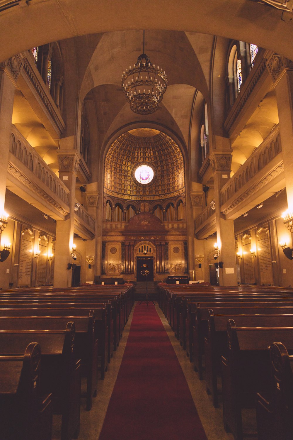 a church filled with pews and a red carpet