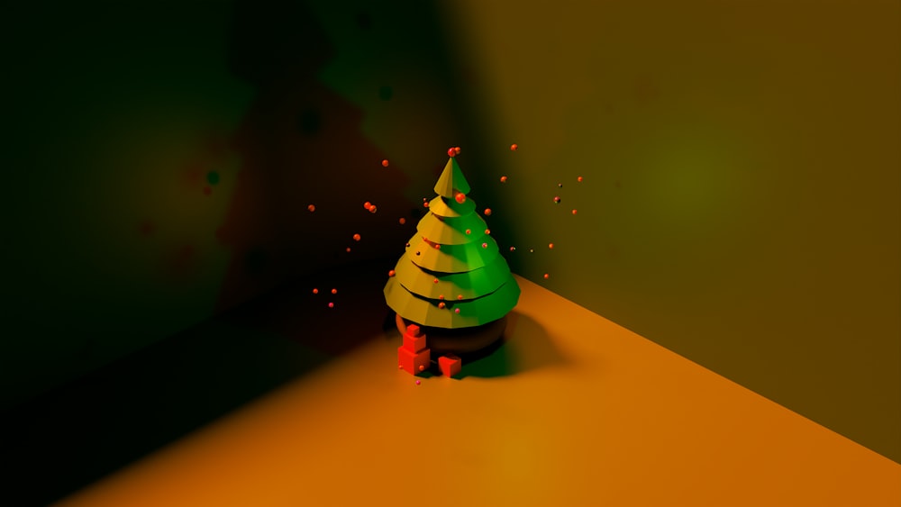 a small green christmas tree sitting on top of a table