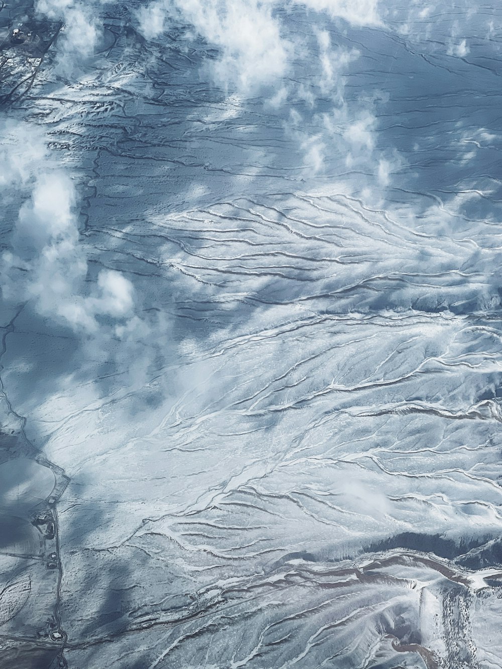 an aerial view of a snow covered mountain range