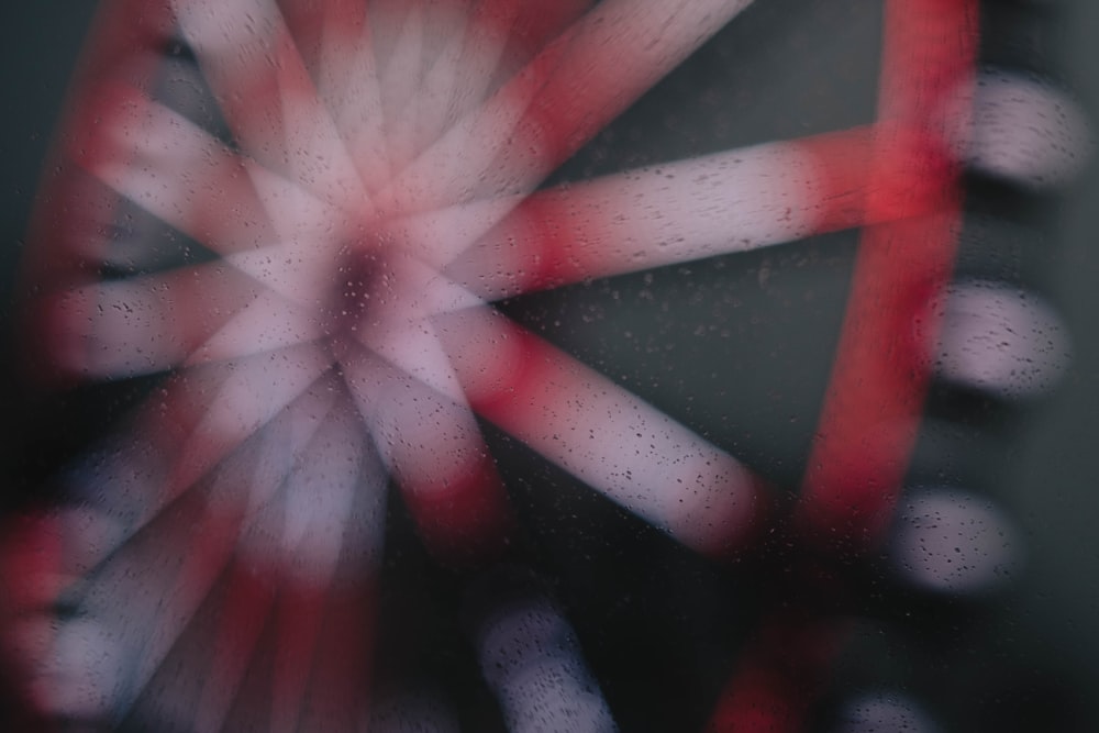 a close up of a ferris wheel on a rainy day