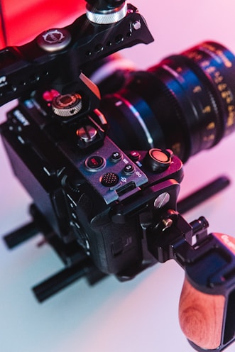 a close up of a camera with a wooden handle