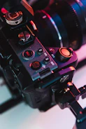 Close-up of a professional camera setup with focus on lens and controls