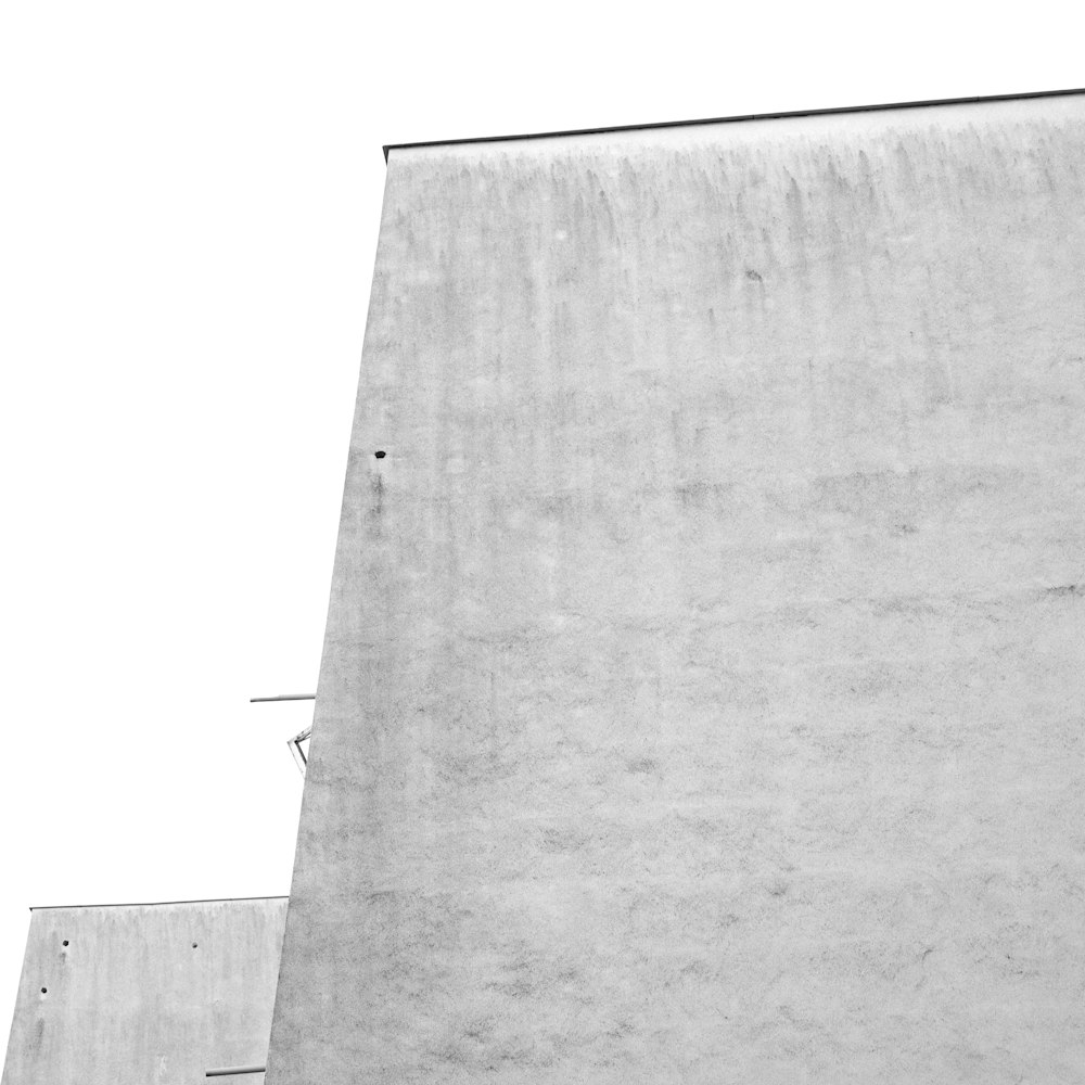 a man riding a skateboard up the side of a cement wall