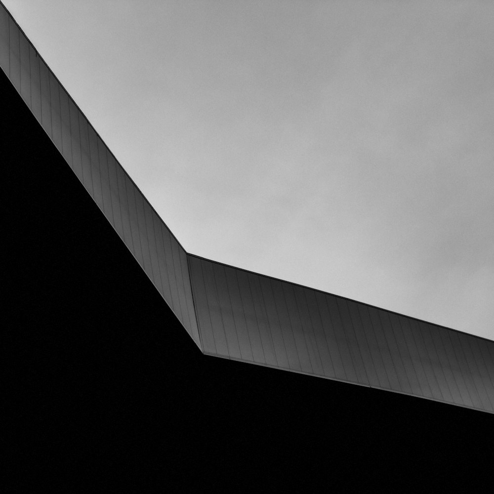 a black and white photo of a plane flying in the sky