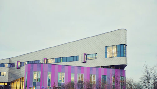 a pink and purple building with a clock tower