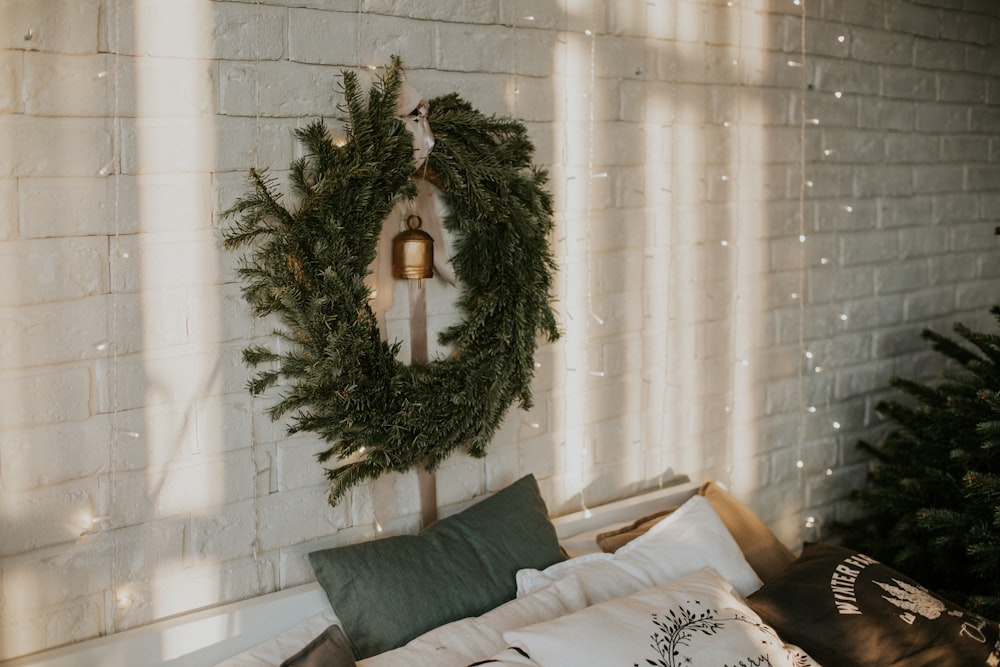 a wreath on the wall above a bed