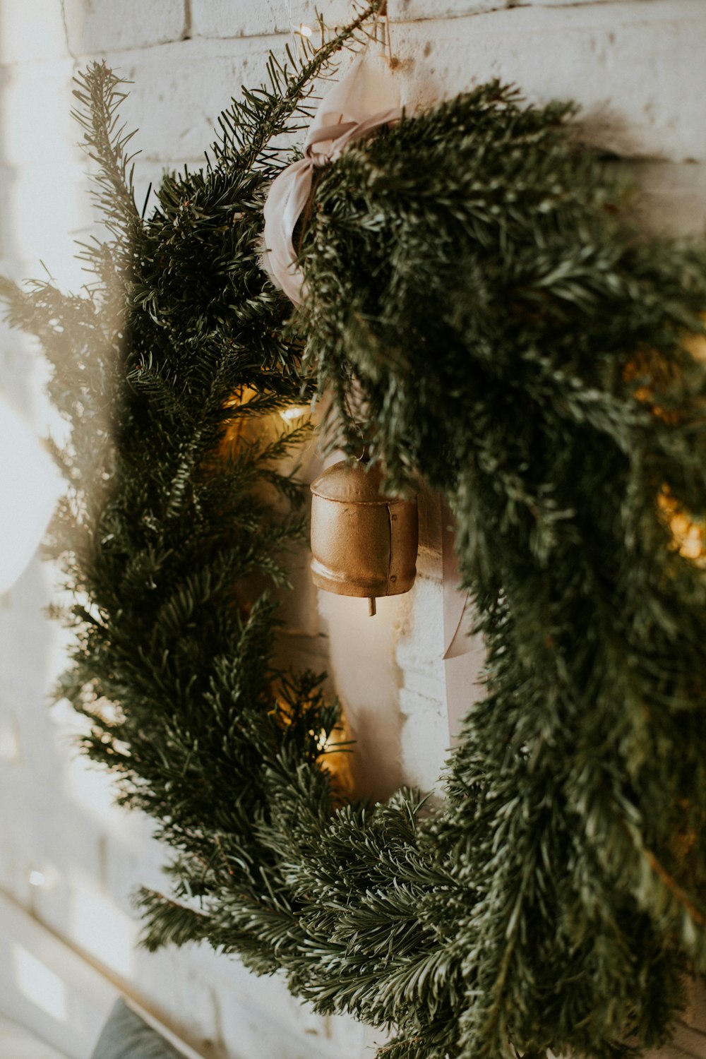 a christmas wreath hanging on a brick wall