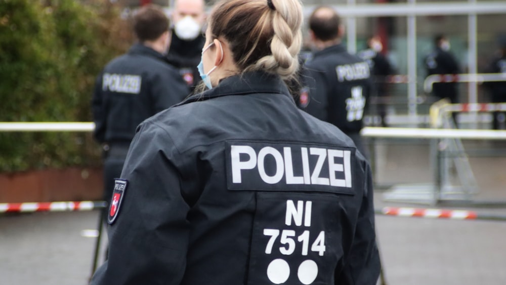 a woman in a police uniform standing in front of a building