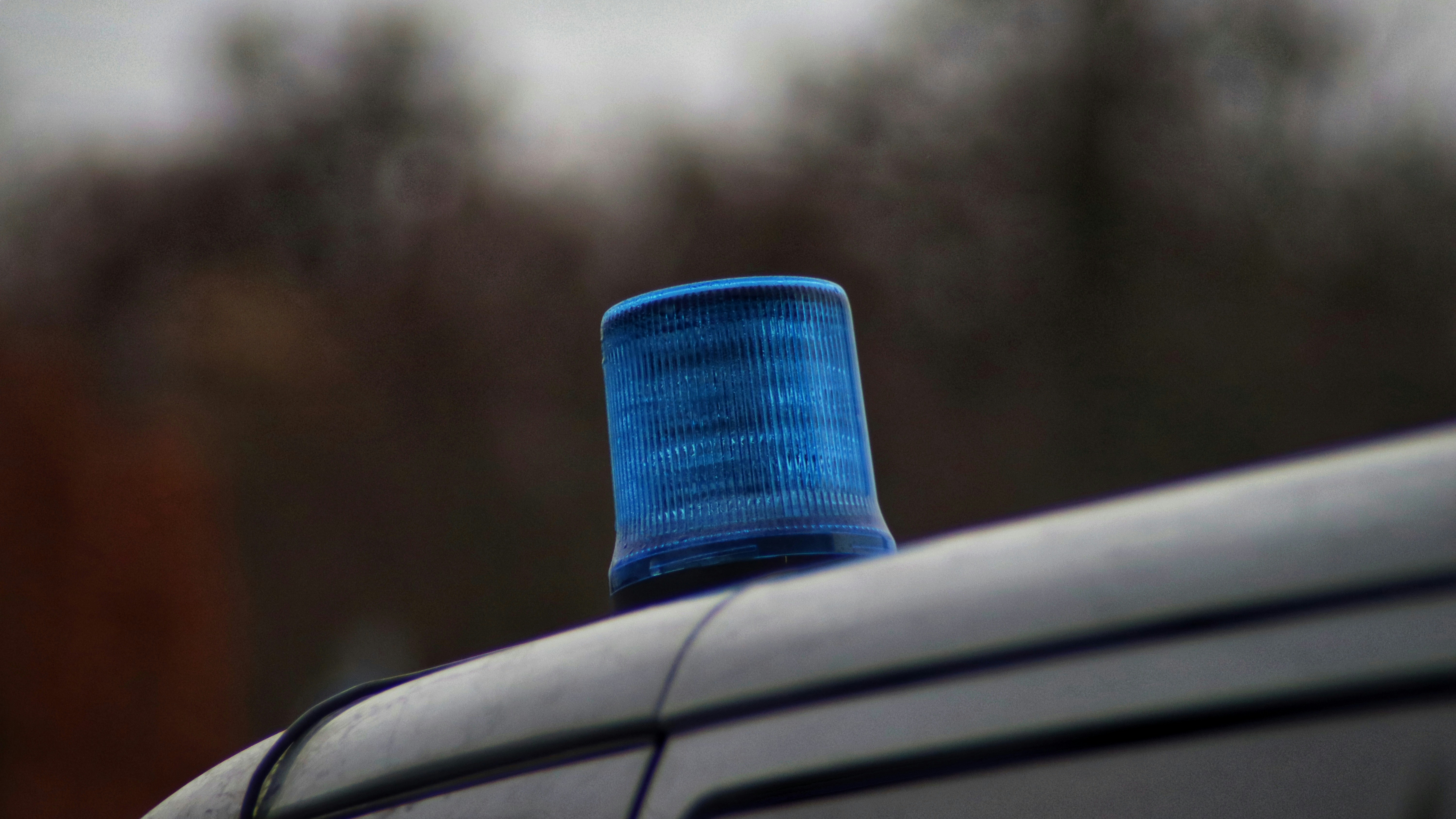 a close up of a blue police light on top of a car