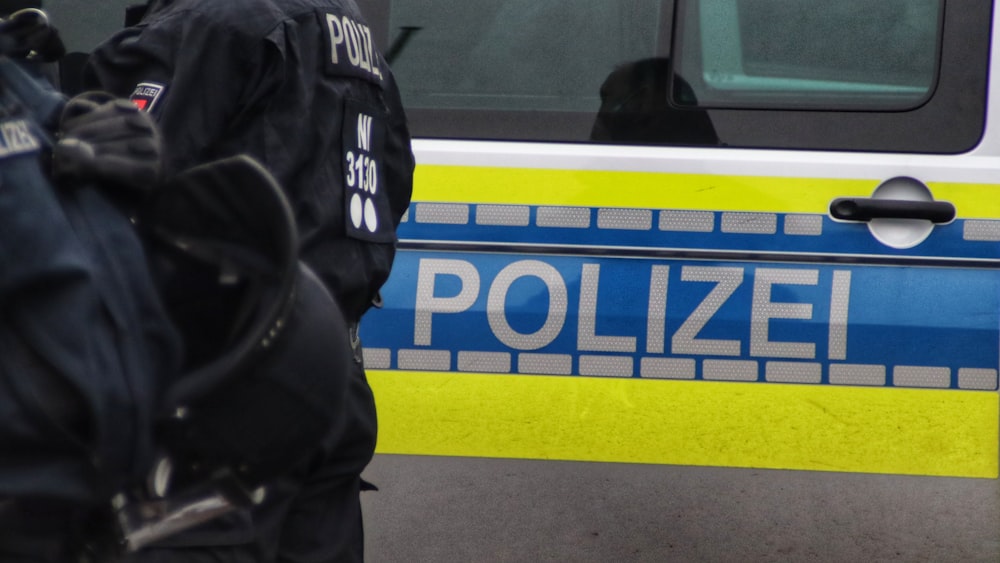 a police officer standing in front of a police car