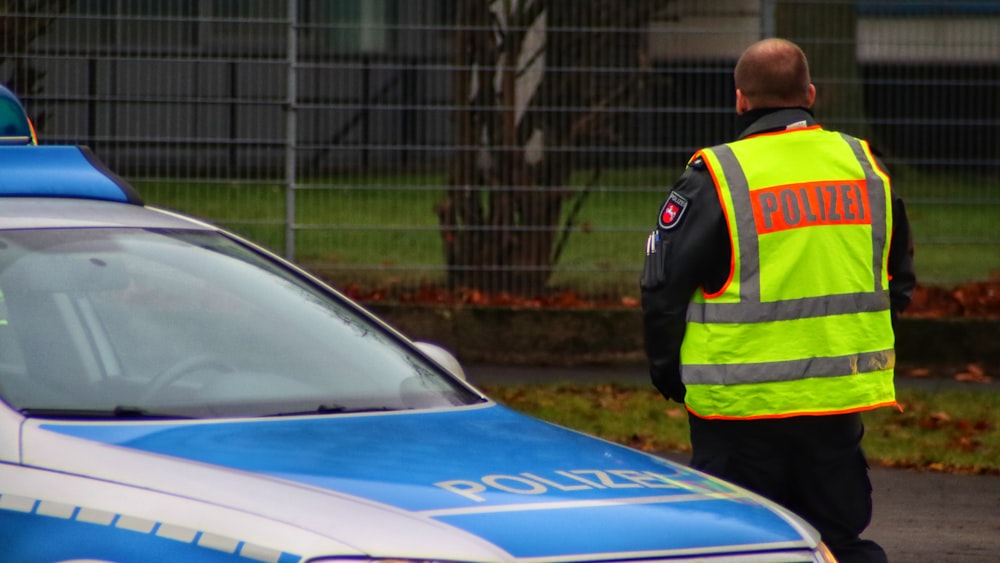 a police officer standing next to a police car