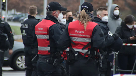 Security team members coordinating with radios at a large outdoor event.