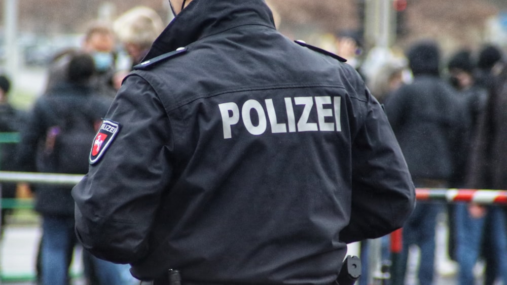 a police officer standing in front of a crowd of people