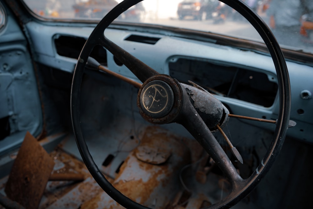 a steering wheel and dashboard of an old car