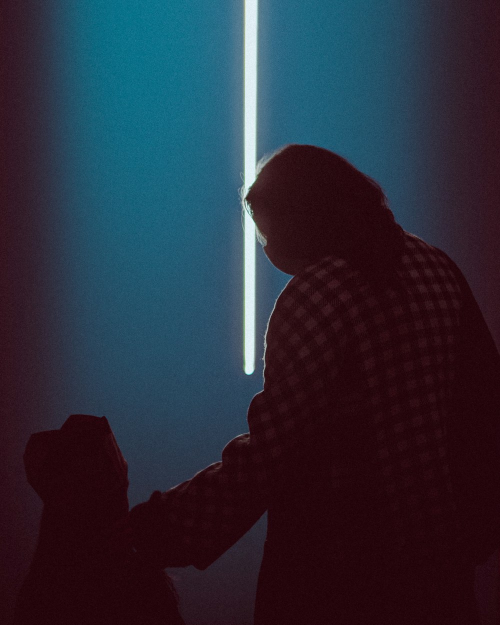A man standing in front of a blue light photo – Free Light Image on Unsplash