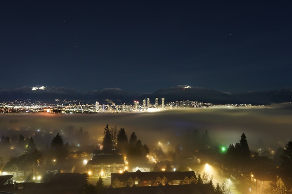 a night view of a city with a foggy sky