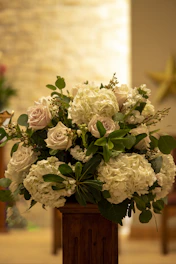 a vase filled with white flowers on top of a table