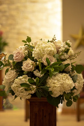a vase filled with white flowers on top of a table