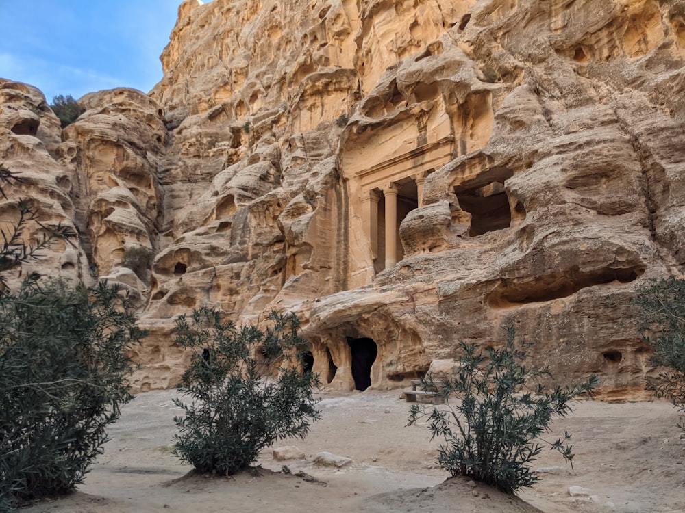 a rock formation with a cave entrance in the middle of it