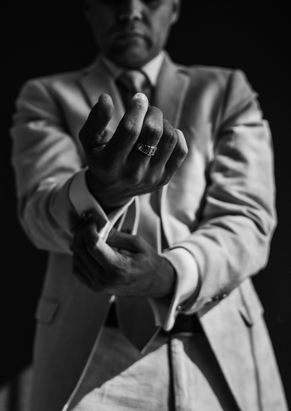 a man in a suit is holding his hand out
