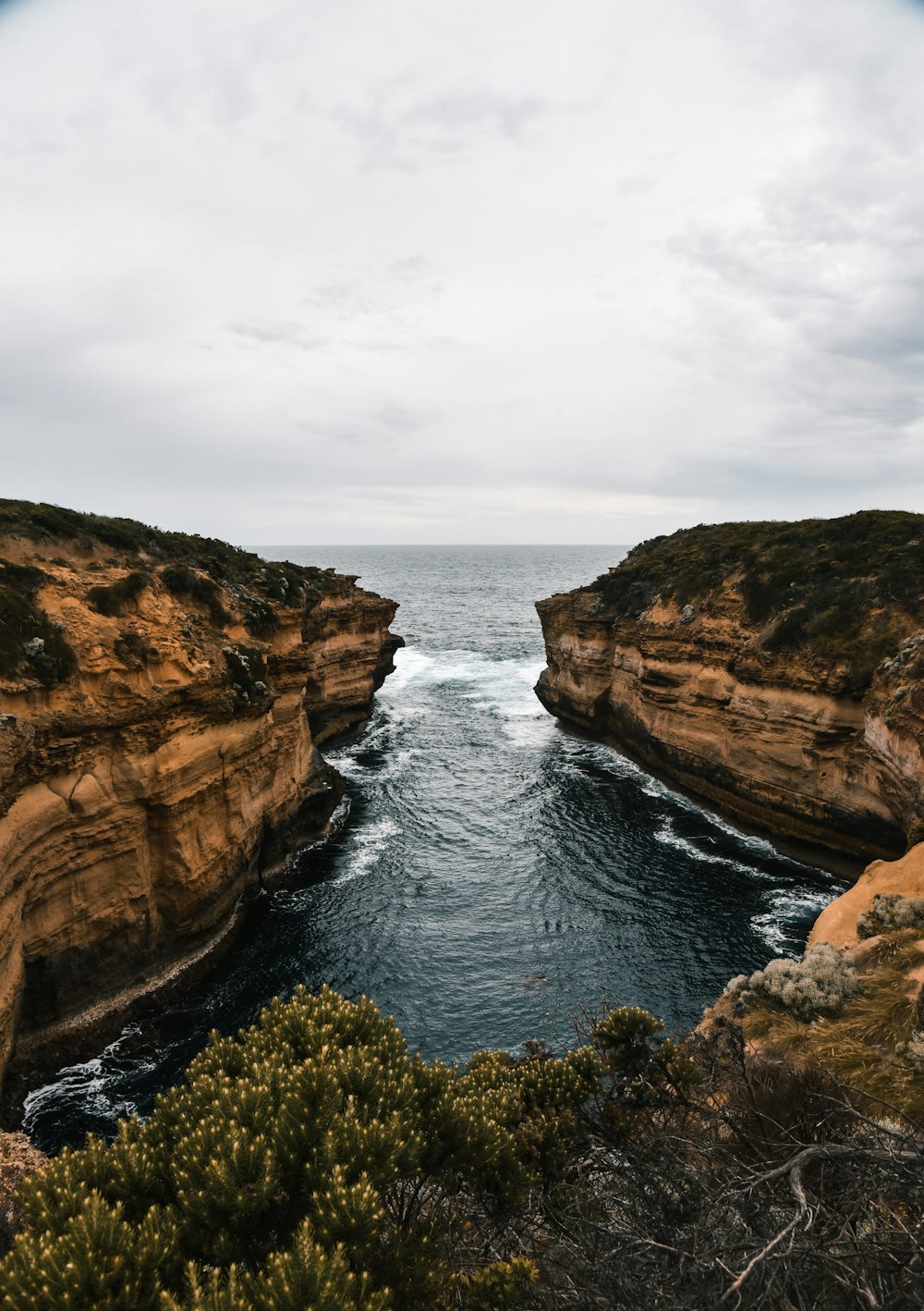 a body of water surrounded by rocky cliffs