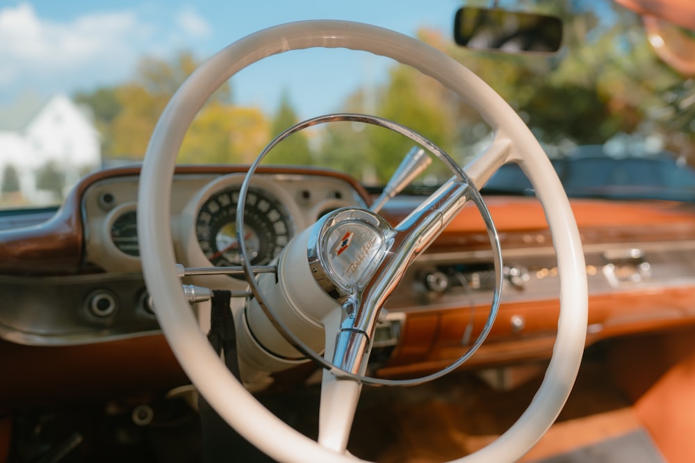 a steering wheel and dashboard of a classic car