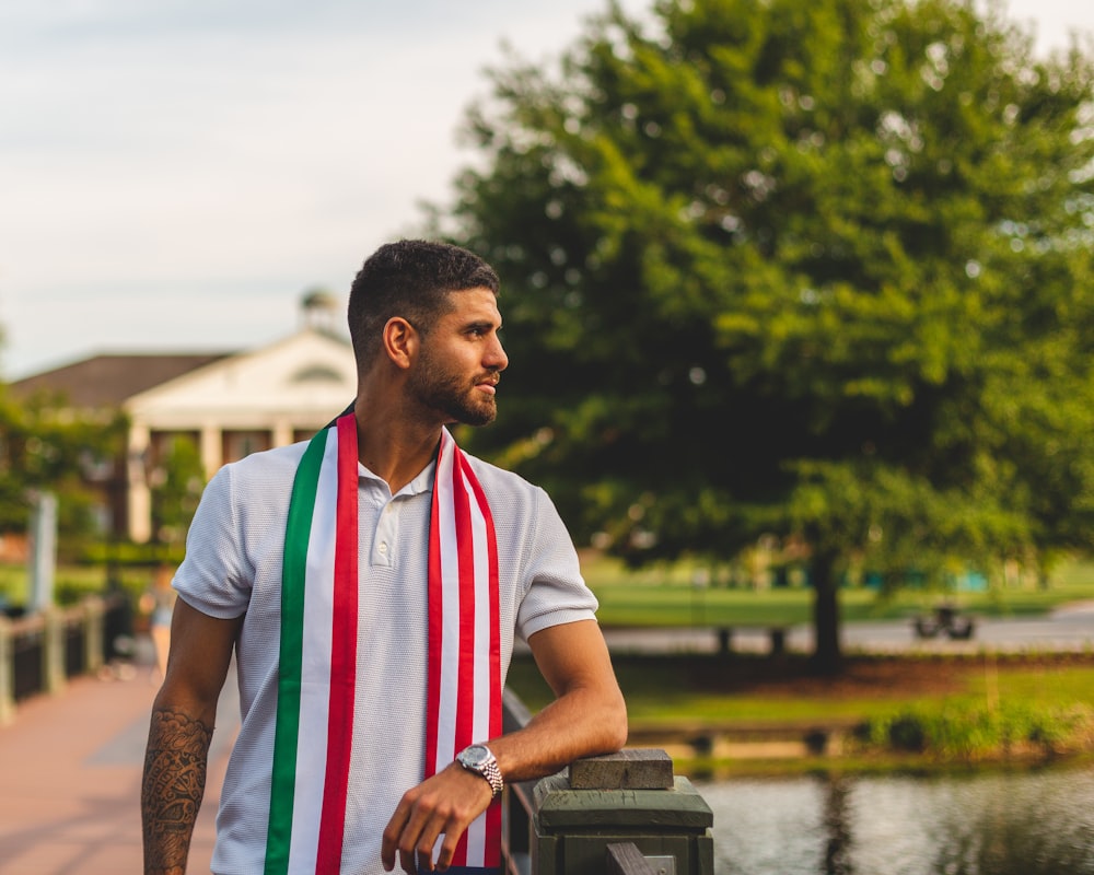 a man wearing a red, white, and green scarf