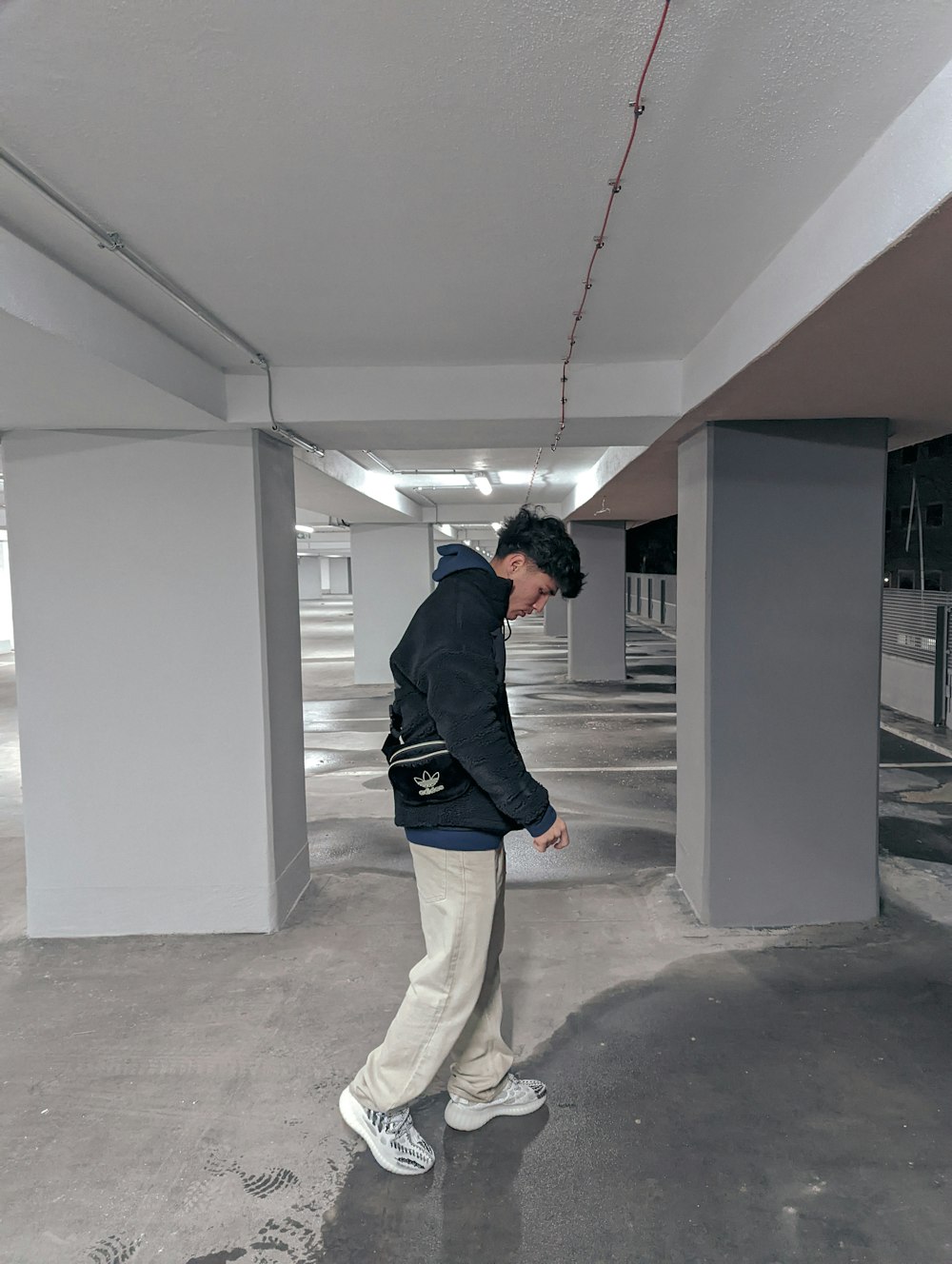 a man is standing in a parking garage