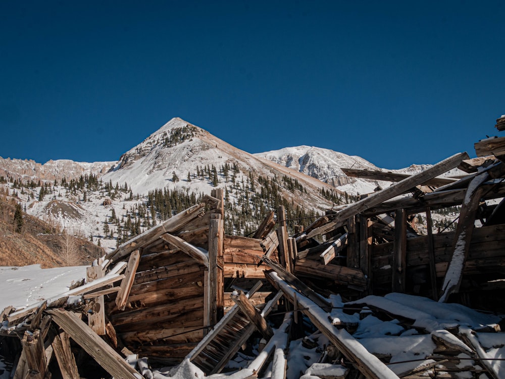a pile of wooden buildings sitting in the snow