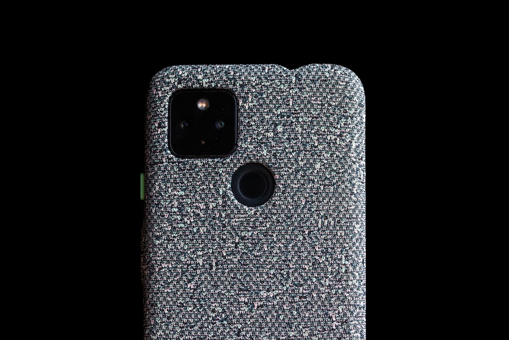a close up of a cell phone on a black background
