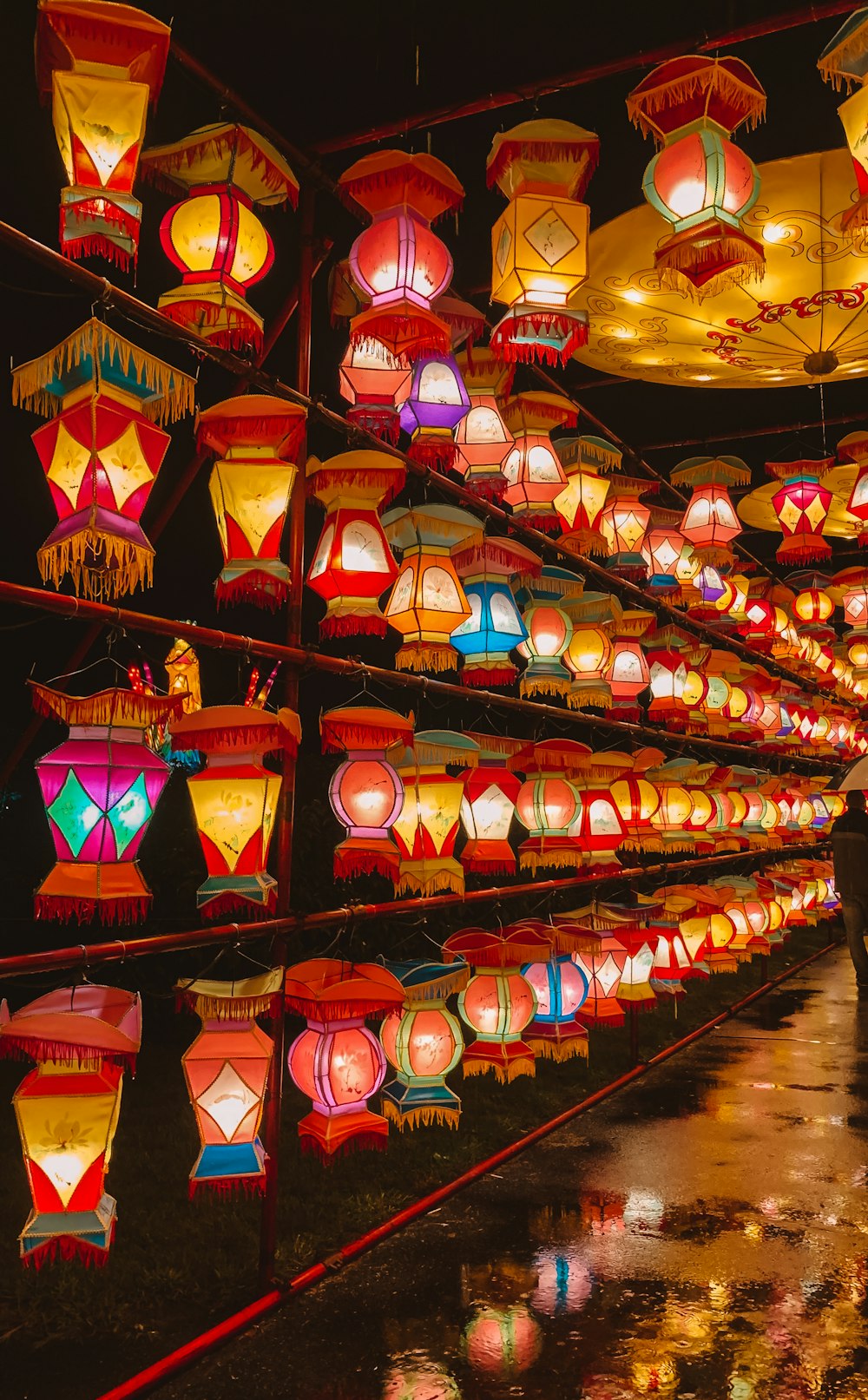 a room filled with lots of lit up lanterns