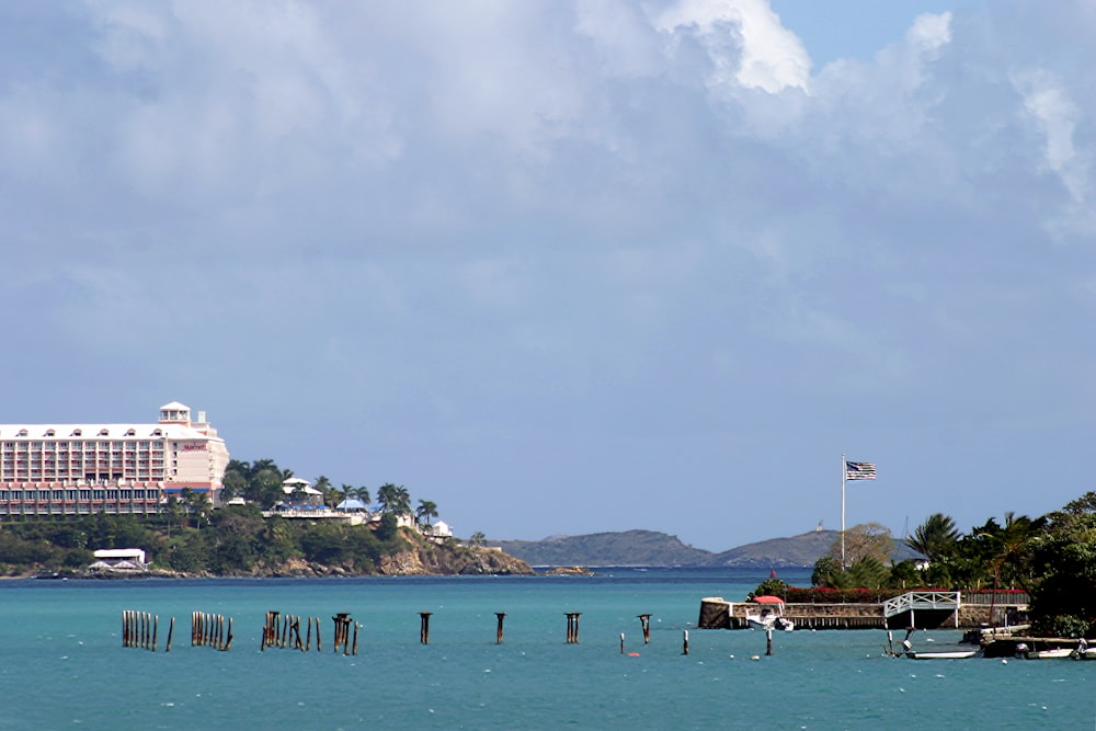 a large body of water with a hotel in the background