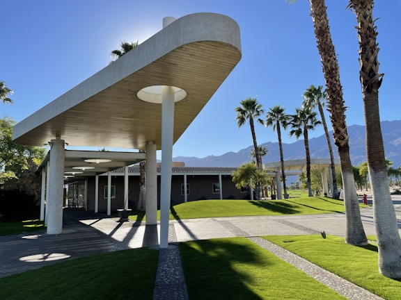 a building with palm trees in front of it